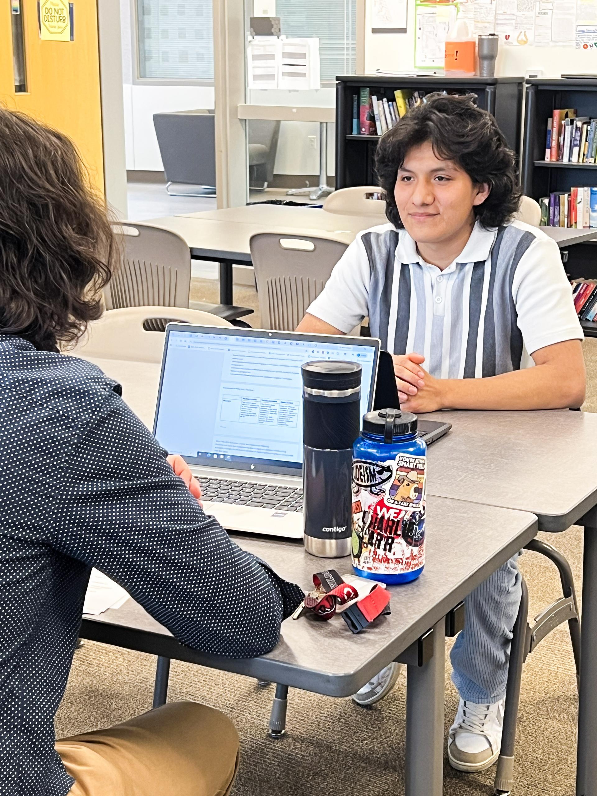 EHS Student participating in exit interview, listening to EHS staff ask a question about their future