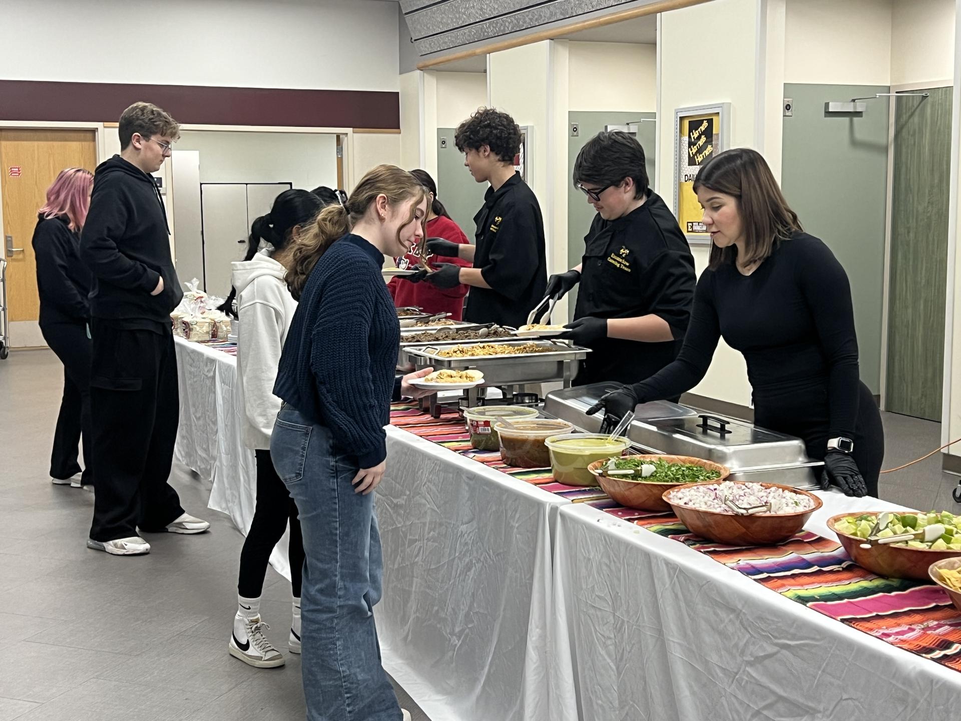 Students and families grabbing dinner at the HIgh School conference event