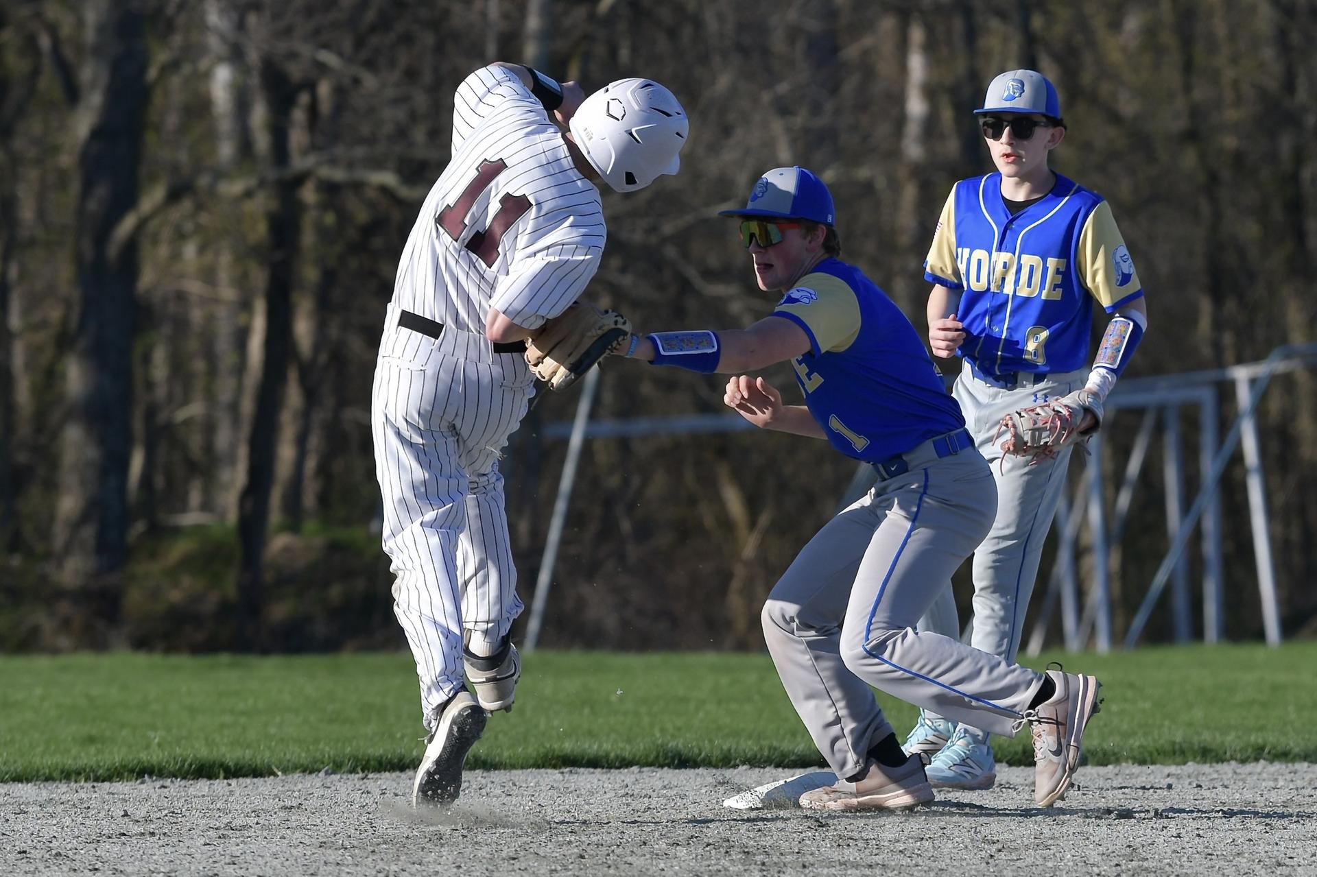 Varsity Baseball teammate, Matthew Ruigrok tags opponent out. 