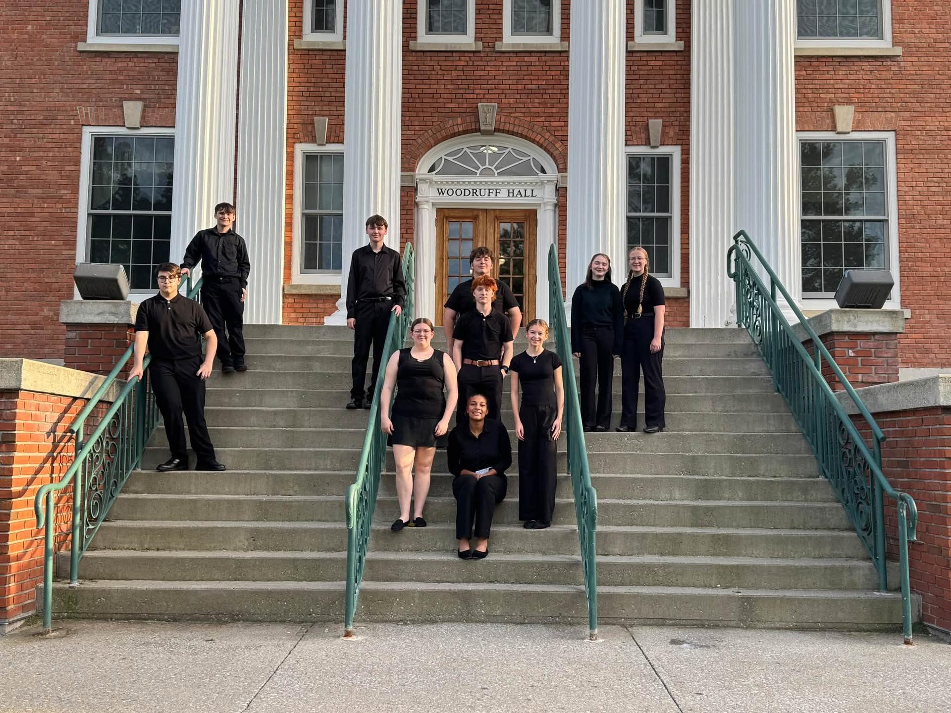 A group of band students stand on steps in front of Woodruff Hall, Castleton, VT, VSU
