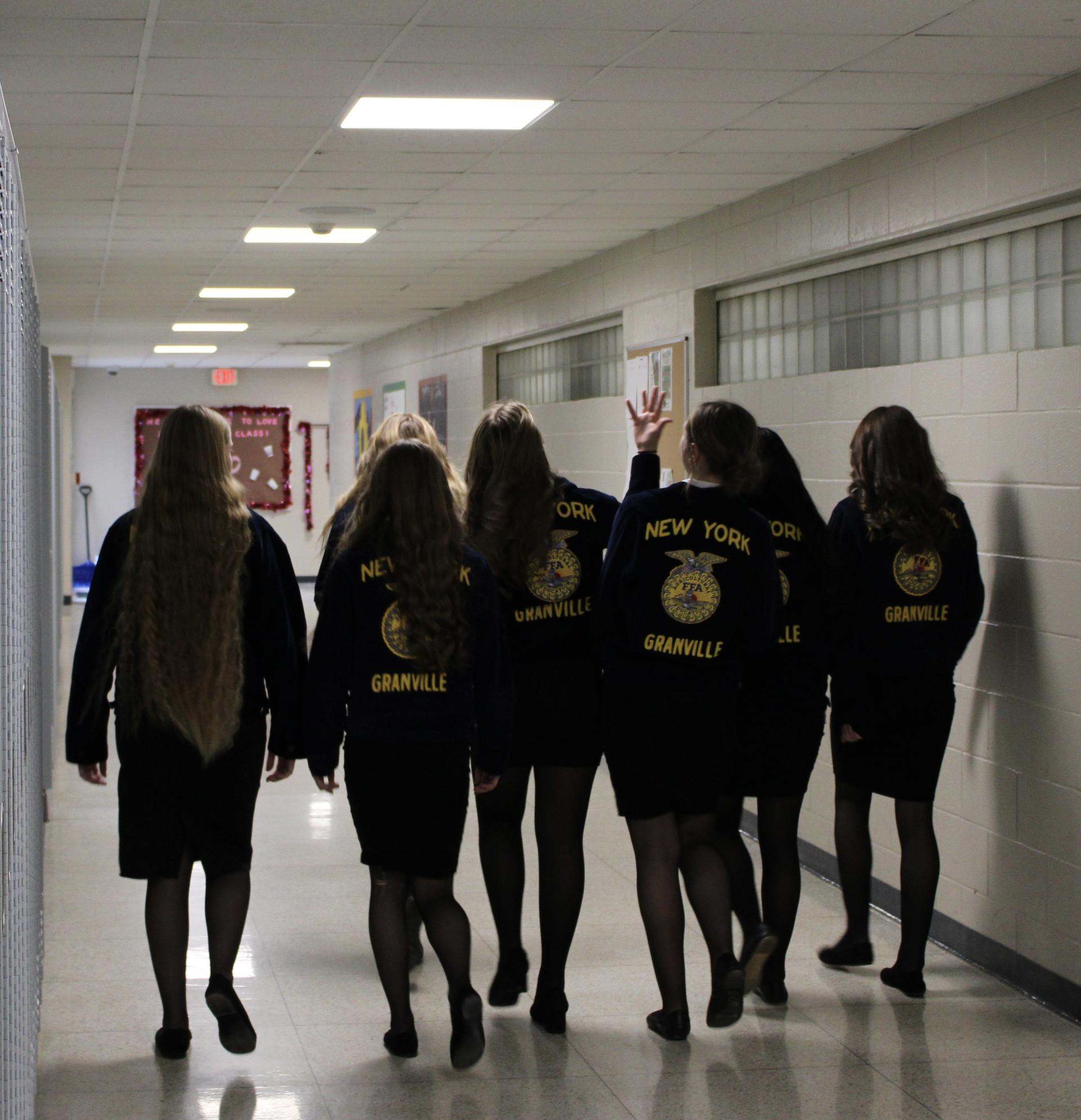 A group of FFA teens walking the hallways of the Jr/Sr High in their Granville FFA jackets