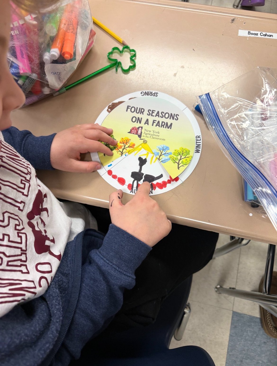 An MJT student shows their Four Seasons on the Farm project