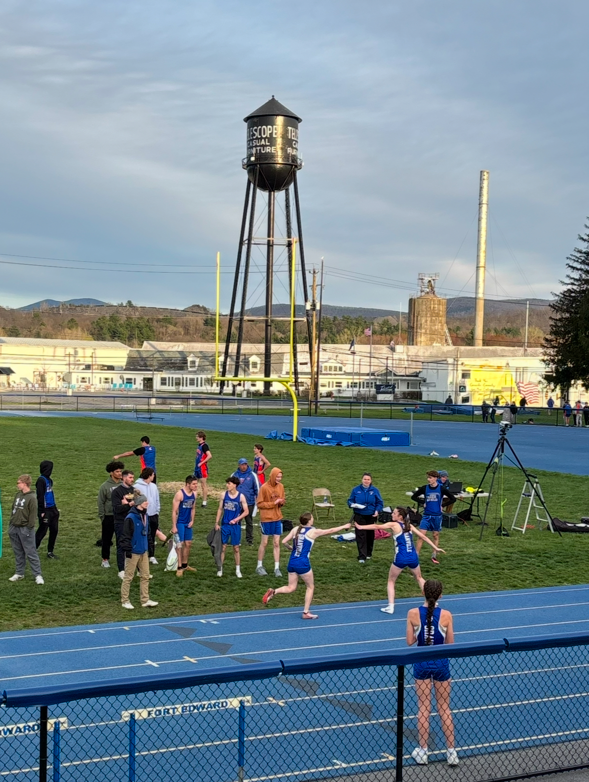 Cali Powell hands off to Kaitlynn Bascom at this week's meet against Lake George and Corinth-Hadley-Luzerne. 