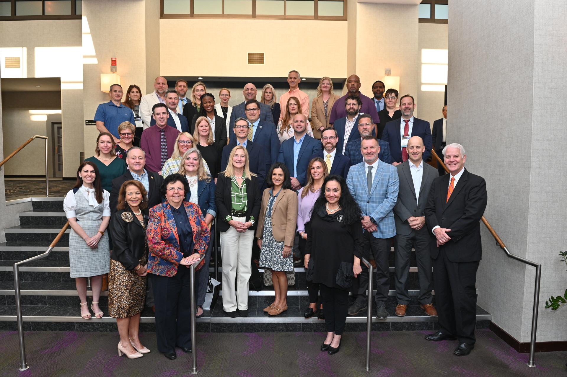 Mr. Hall is with a group of new superintendents at a NYS Council of School Superintendents pictured with NYS Commissioner of Education Dr. Betty Rosa in the front in black