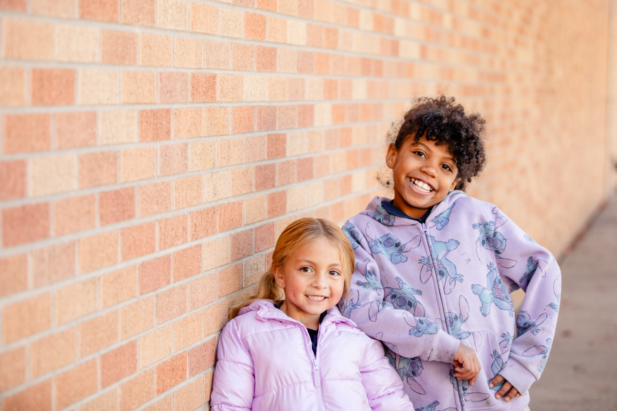 Three students pose for a photo in gym class. 