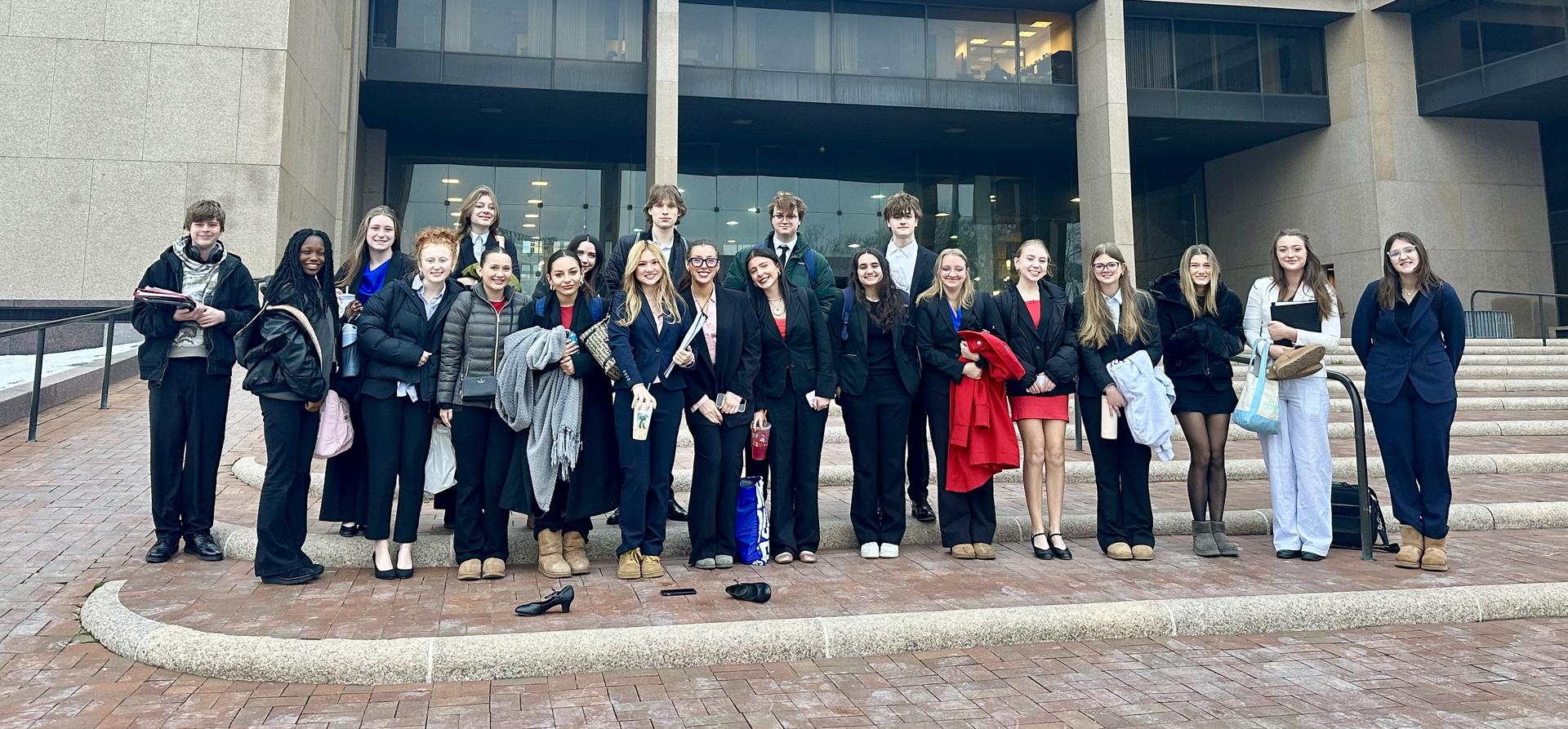 Group of students on the Mock Trial Team standing outside a building