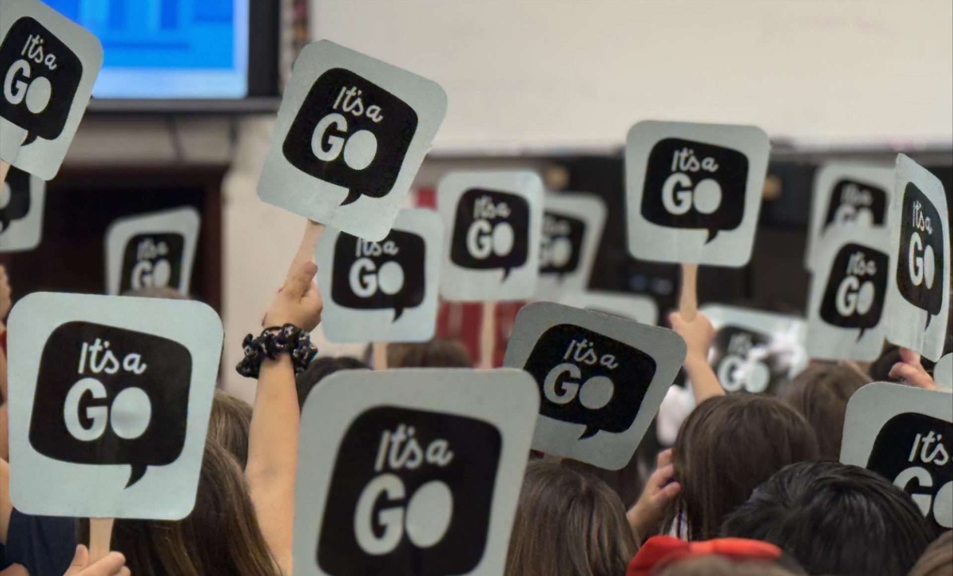 'It's a GO' signs held by students