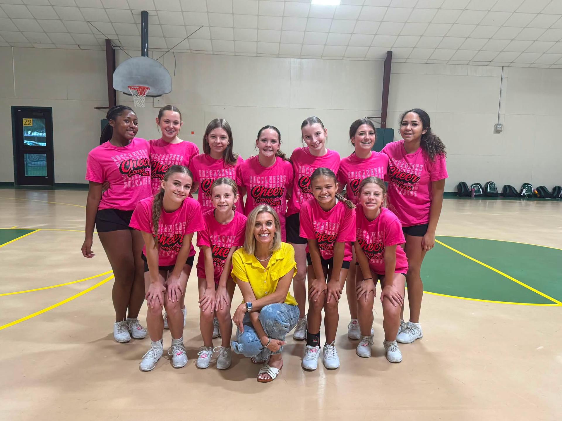 eleven team members and a coach in a gym