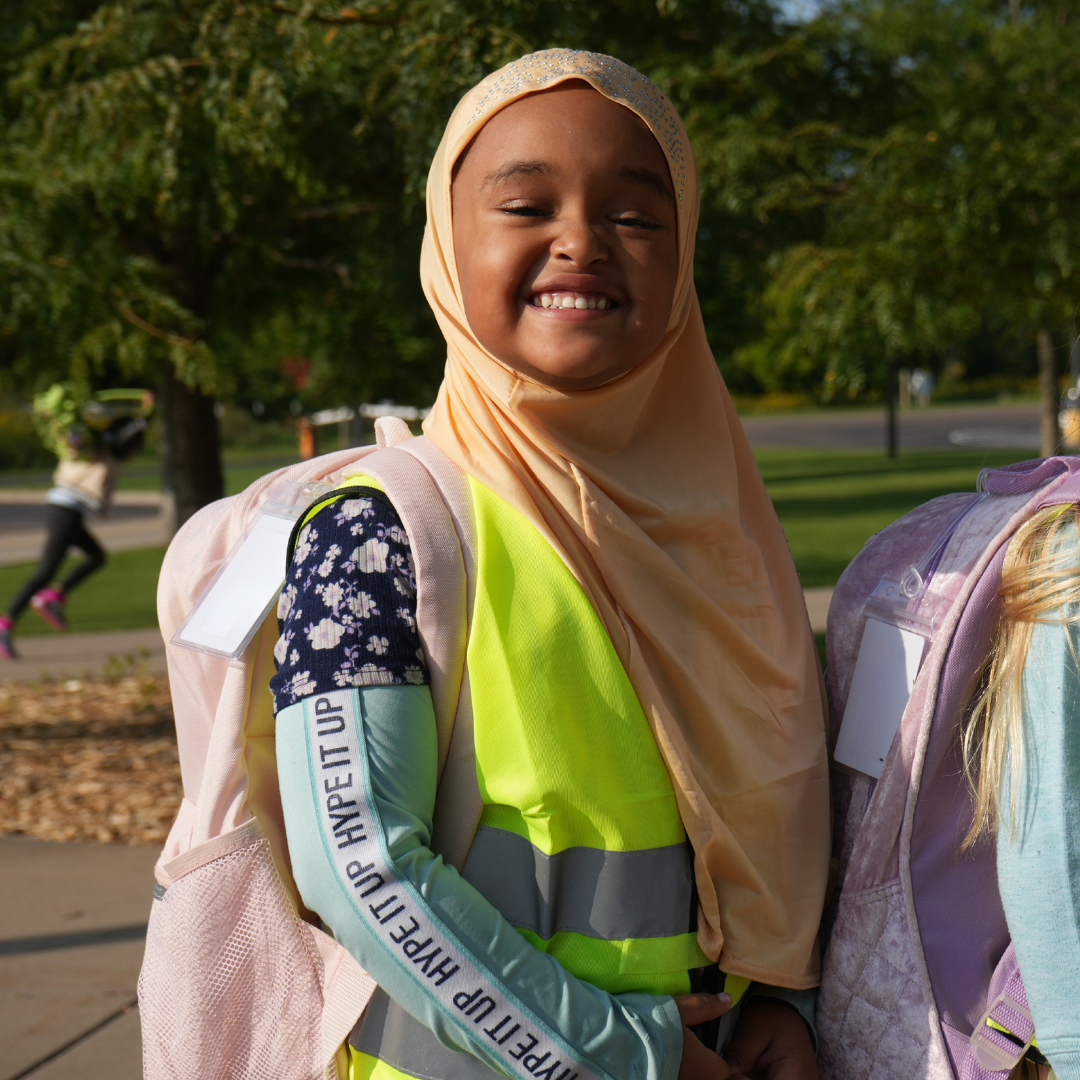 Preschool student wearing bus vest