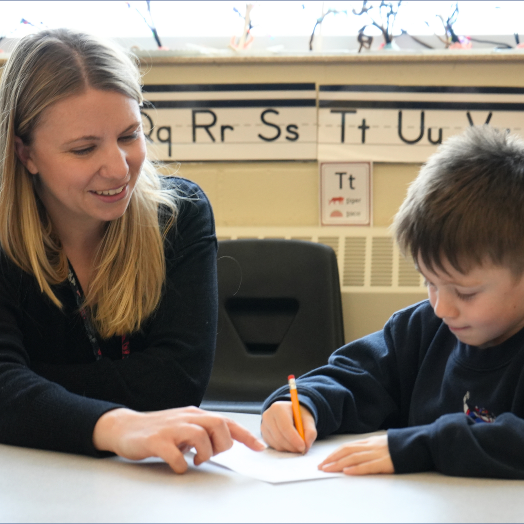 Early childhood teacher instructing student 