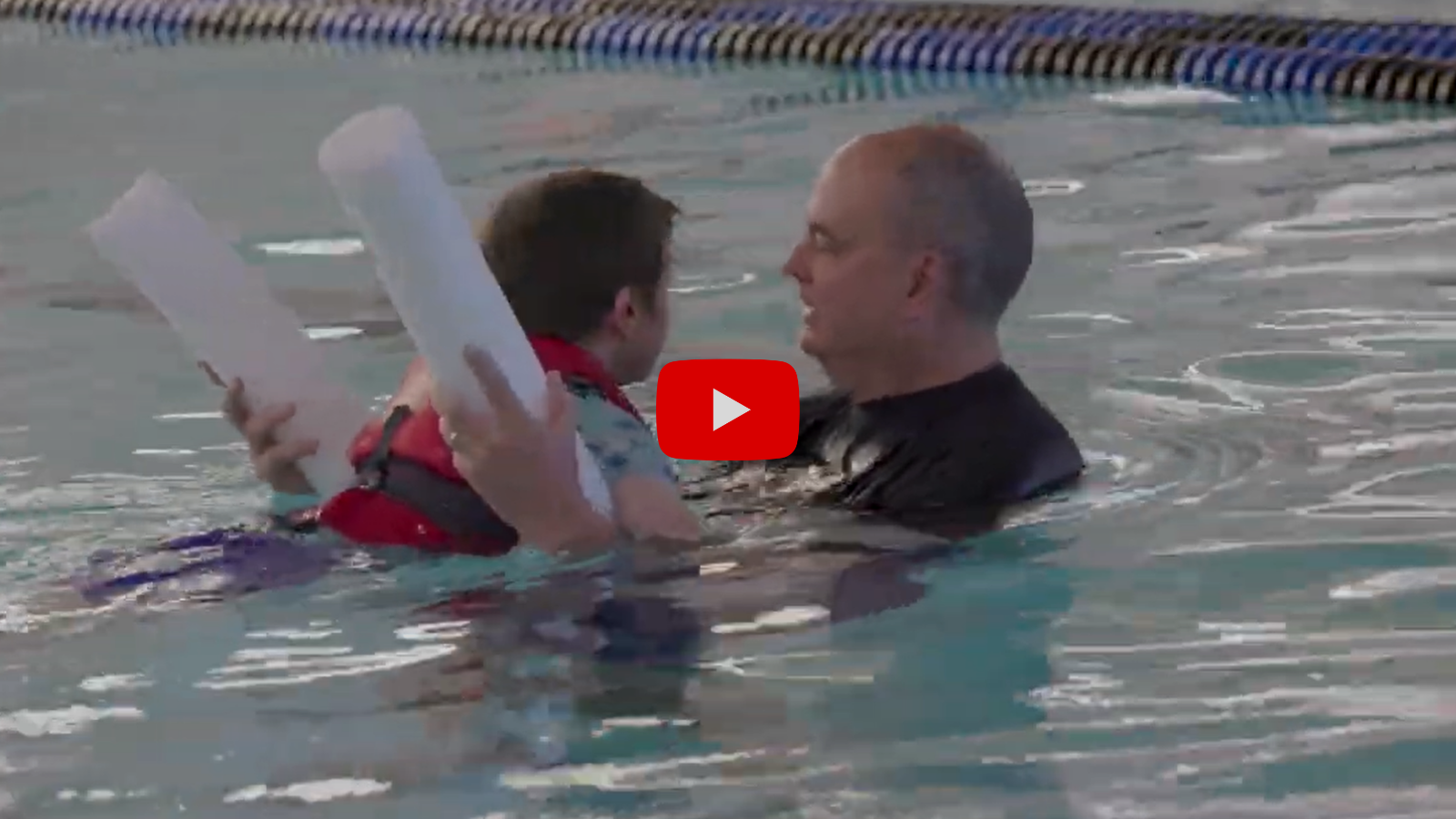 PE Teacher Supporting Student in a Pool - Video Club