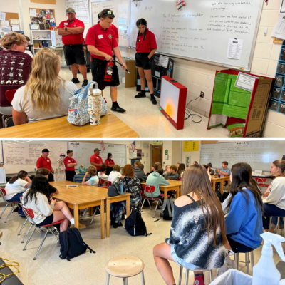 Firefighters speaking to a high school class of students.