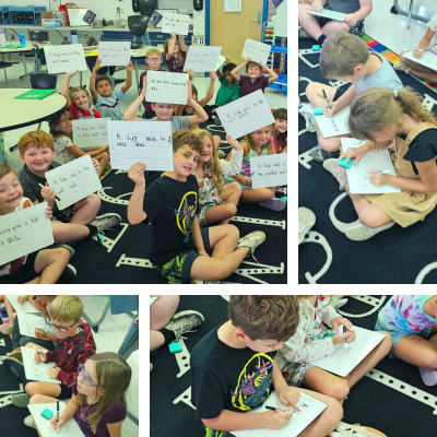 Second graders writing on handheld white boards.