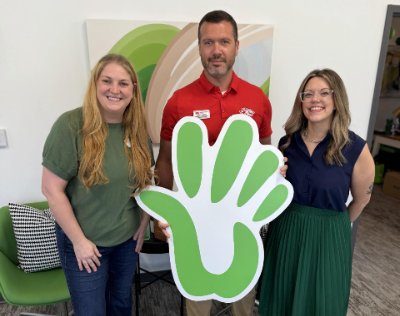 Garet Nunan with two Care to Learn representatives