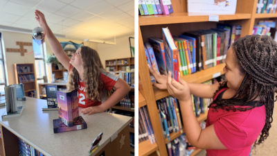 Students arranging books on a shelf in the library