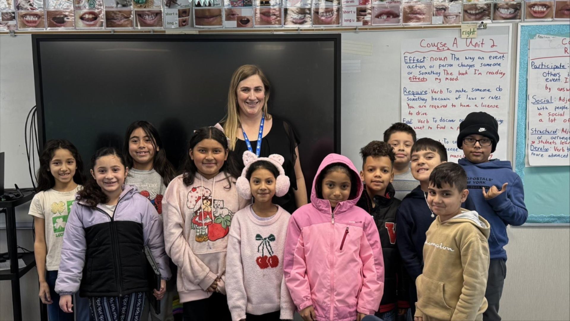 Christina poses for a photo with her third grade students.