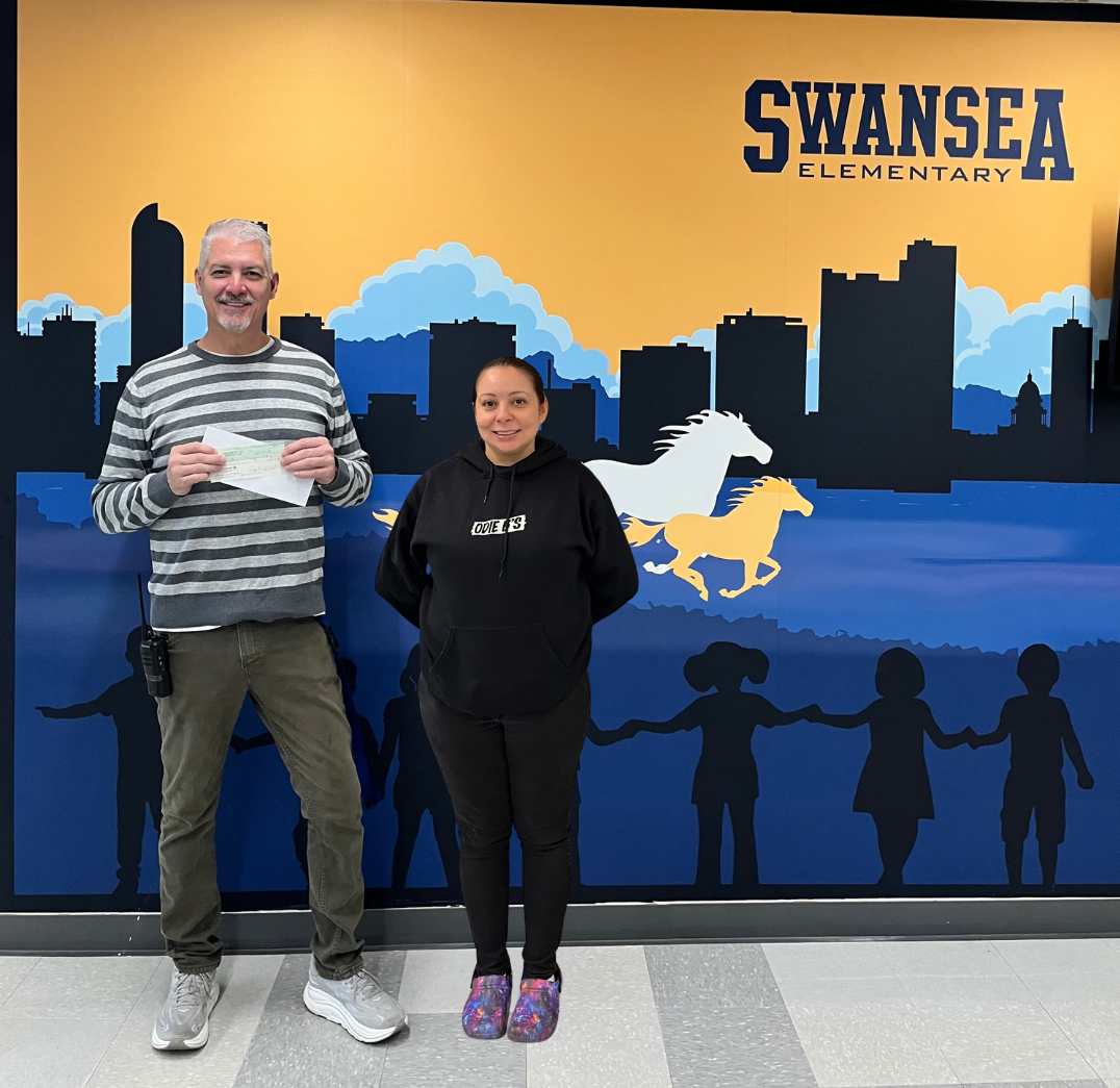 Assistant Principal Marc and Odie B's restaurant manger pose for a photo. Odie B's donated $188 to the school. 