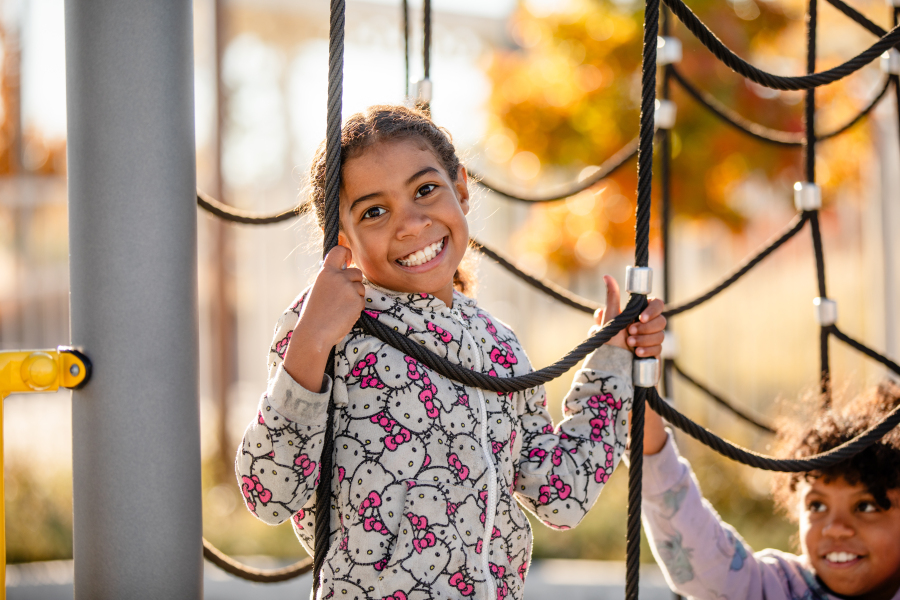 Four students smile for a photo on the Swansea Elementary Playground.