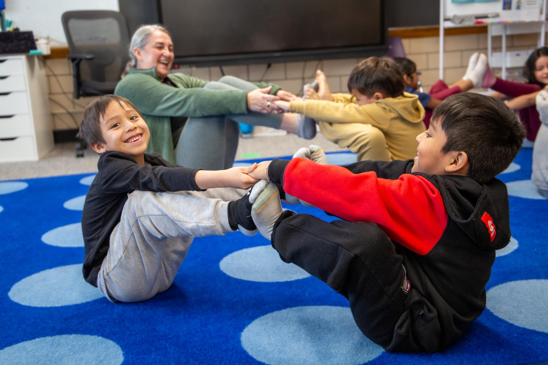 Two students practice yoga at Ellis Adventure day.