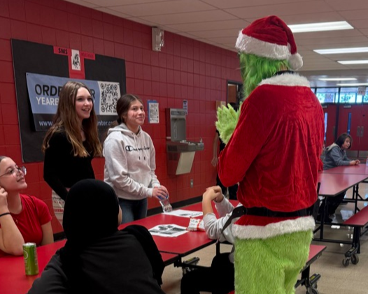 The Grinch talking to students 