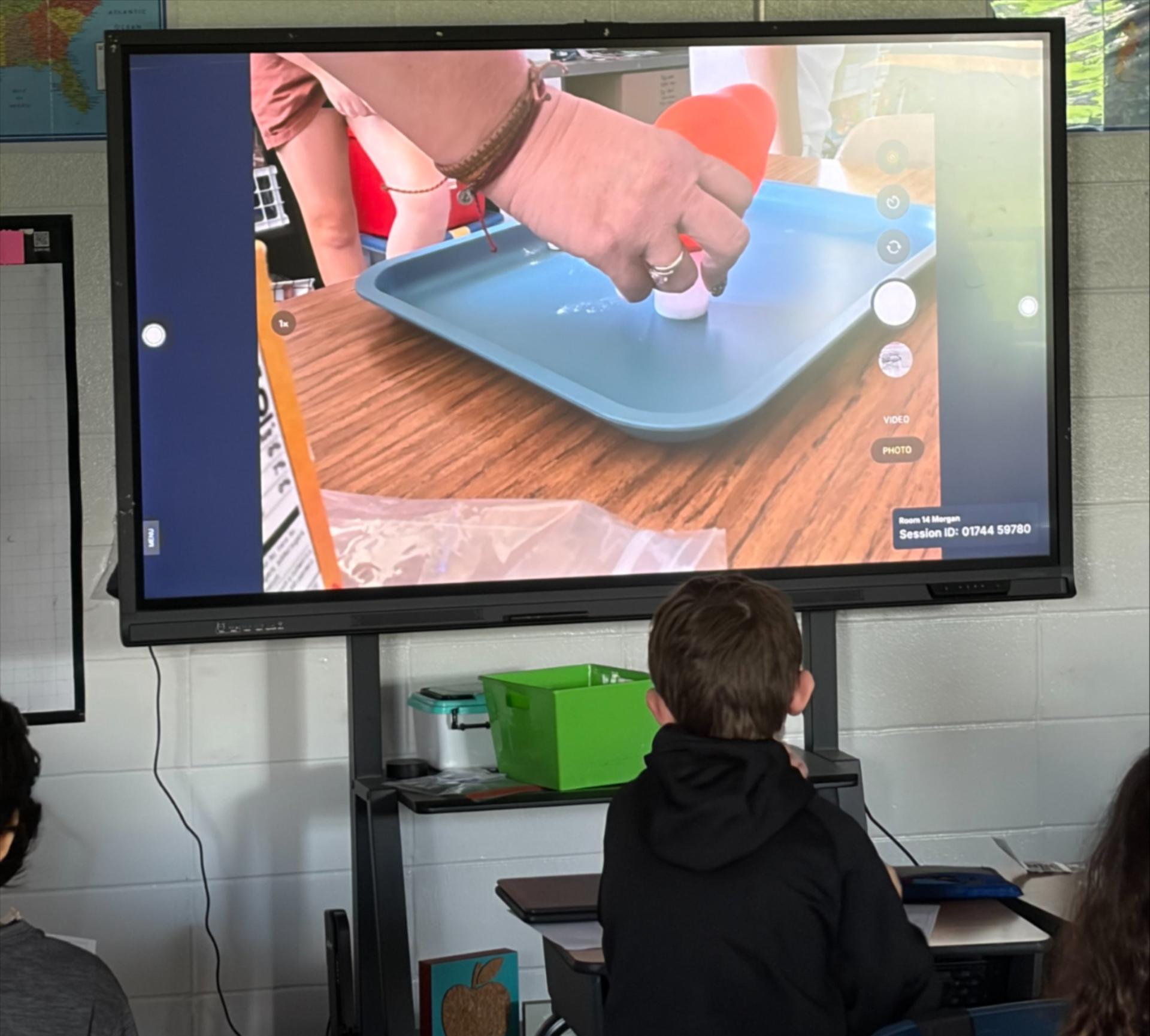 A television showing a science demonstration. 