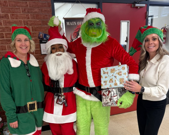 admin team dressed up as elves, santa and the grinch. 