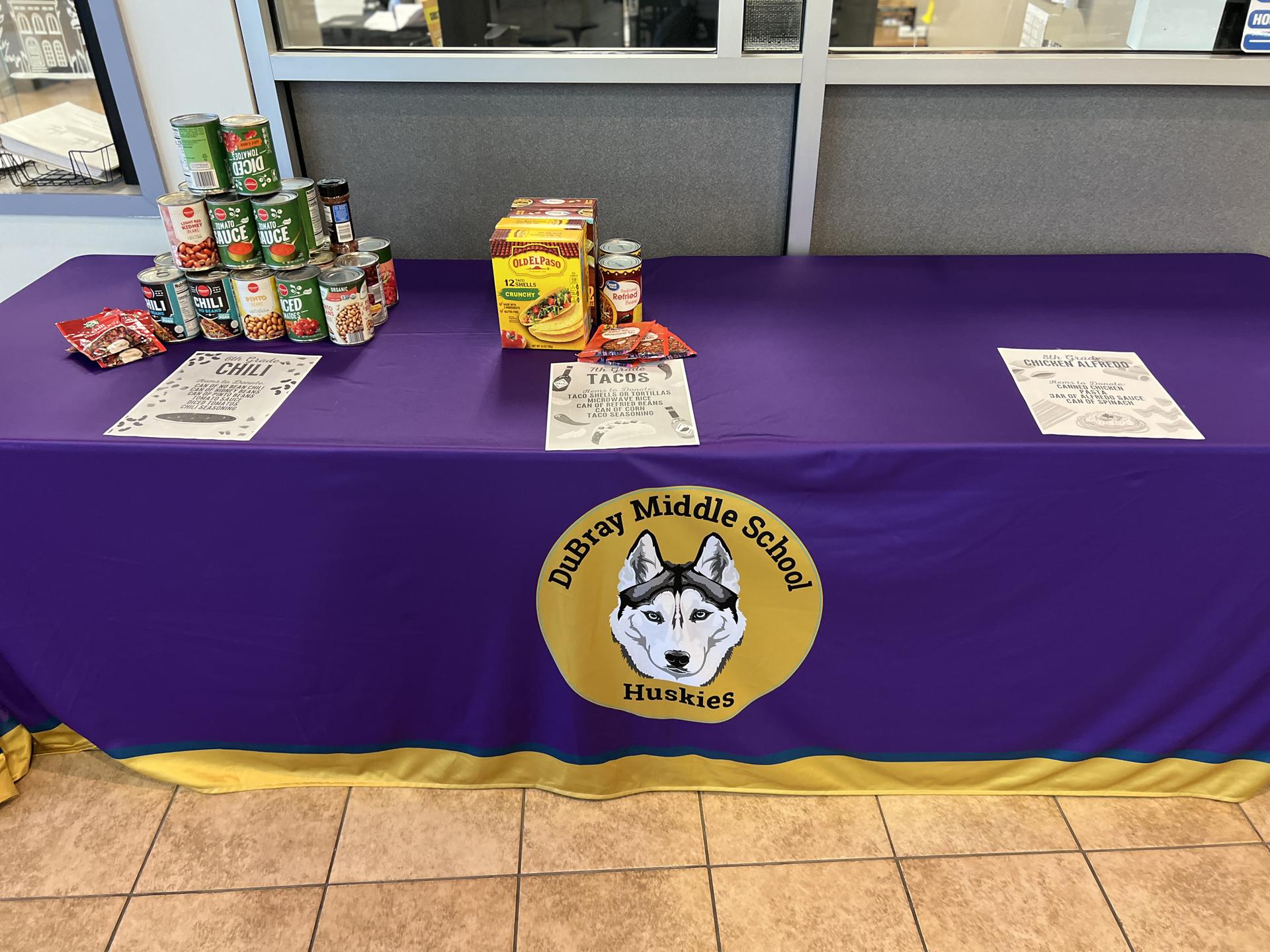 Photo of table and donations after the first day of the NJHS food drive.