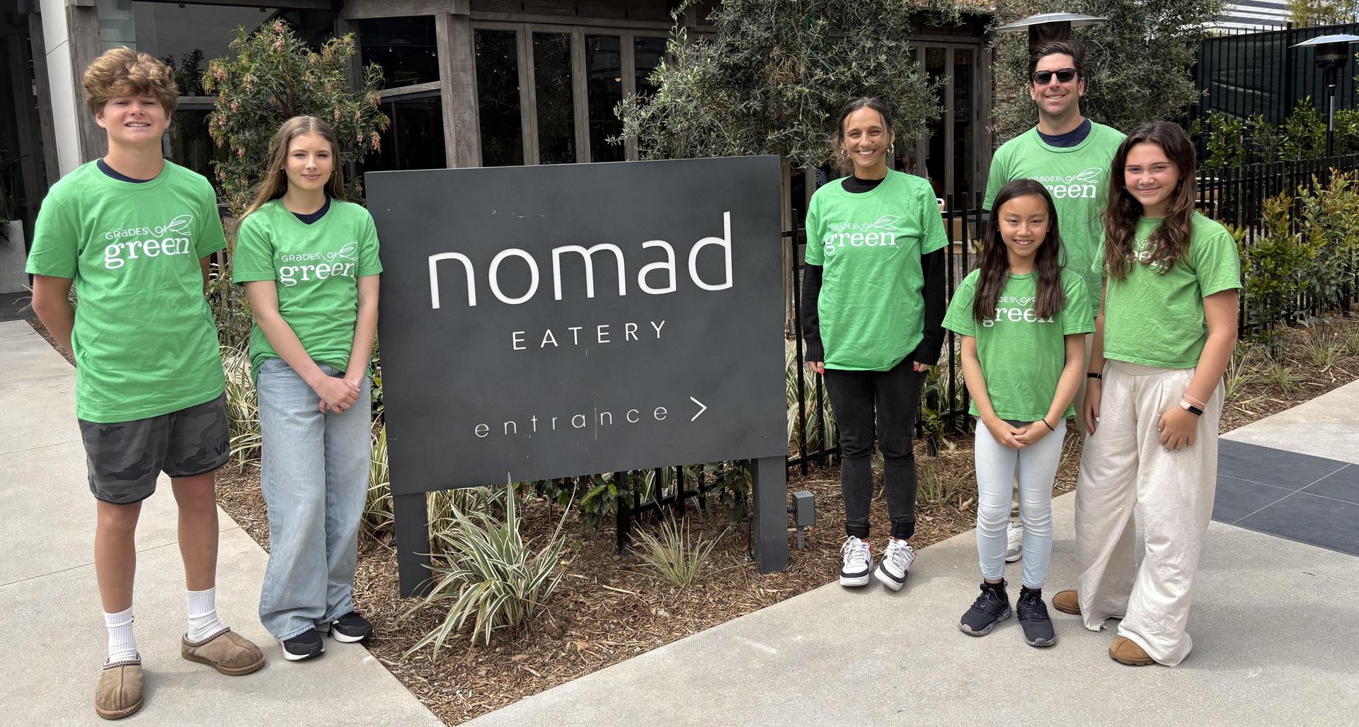 club members by restaurant sign