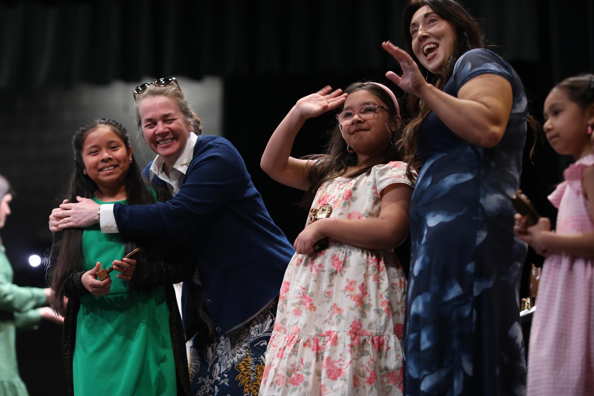 Students receiving Young Georgia Authors Awards smile on stage.