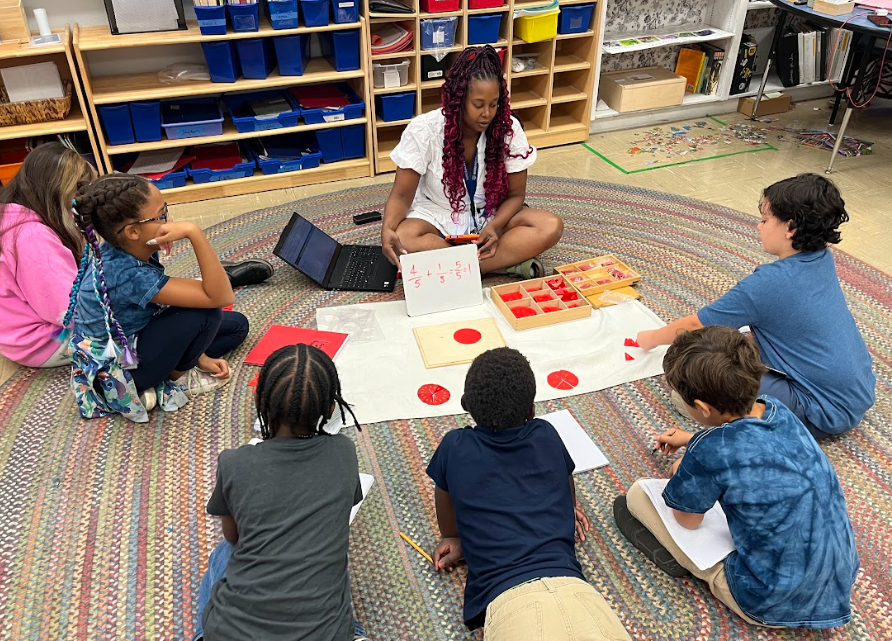 Teacher uses fraction pieces to teach a lesson