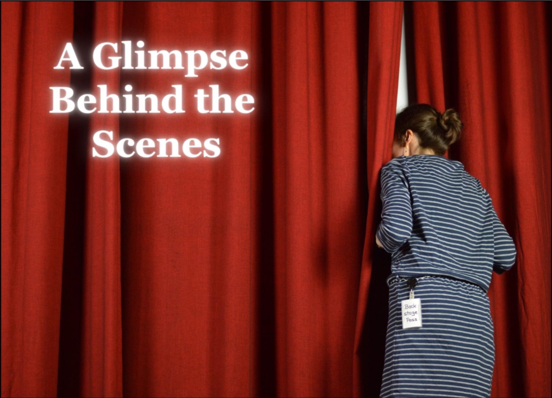 woman peeking behind red curtain