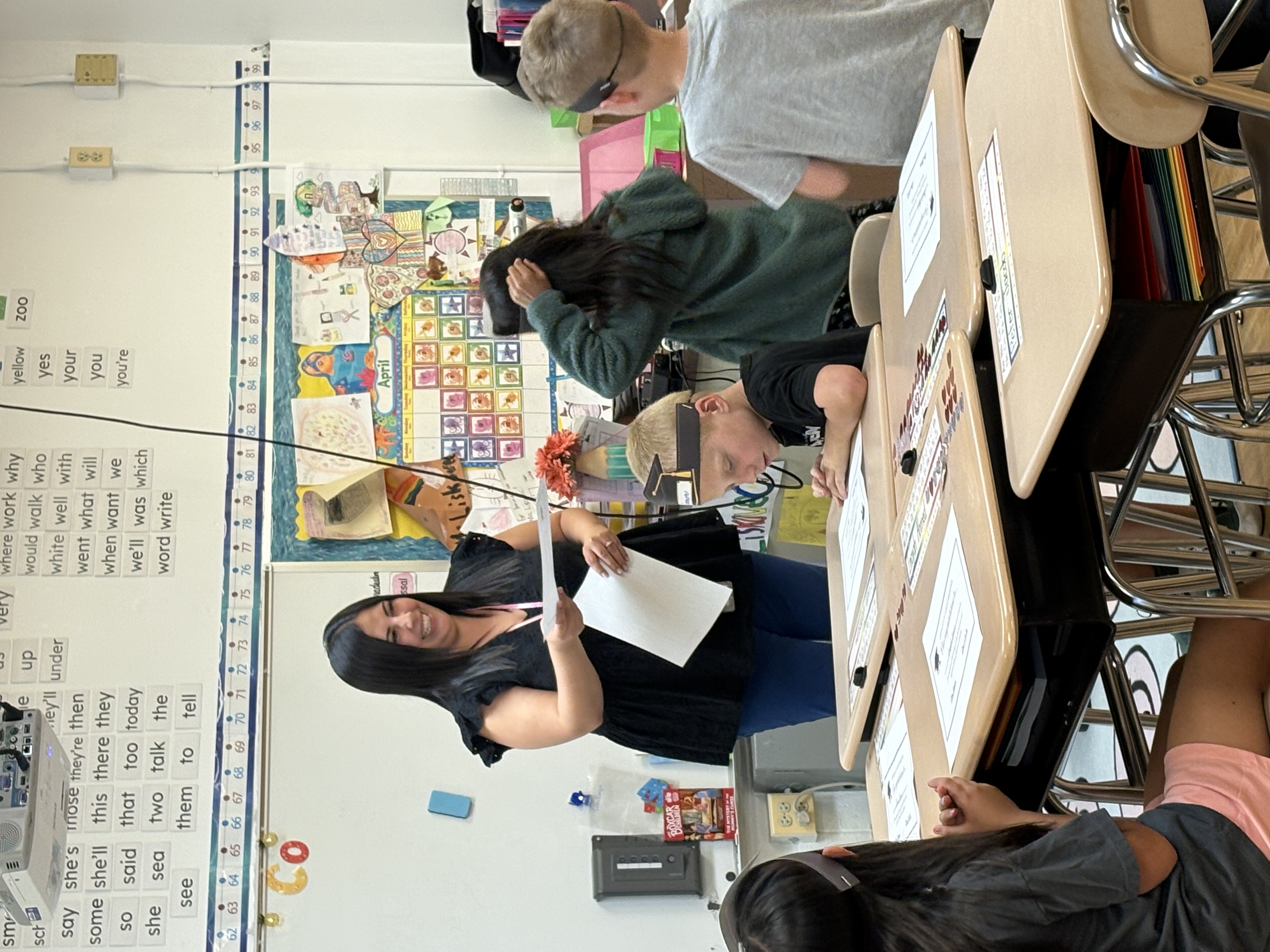 Teacher hands student certificate