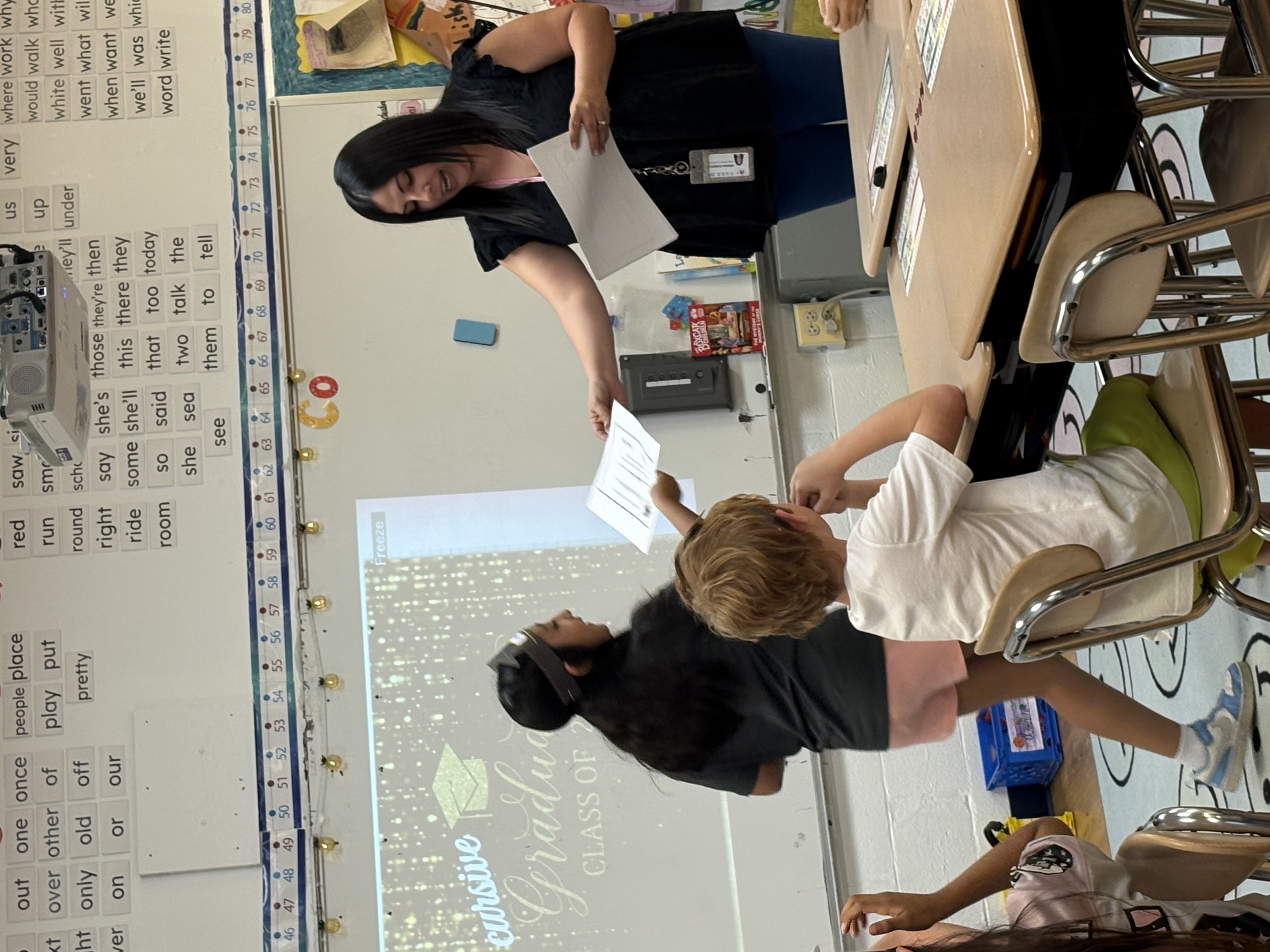 Teacher hands student certificate