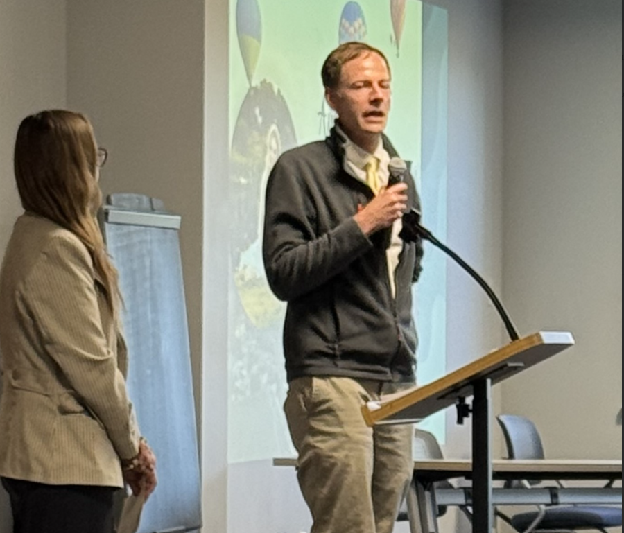 Bill Kardas speaking at ACIE completion ceremony with Sarah Crowe looking on