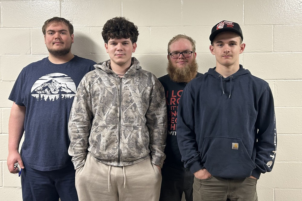 Four pre-apprenticeship students posing together