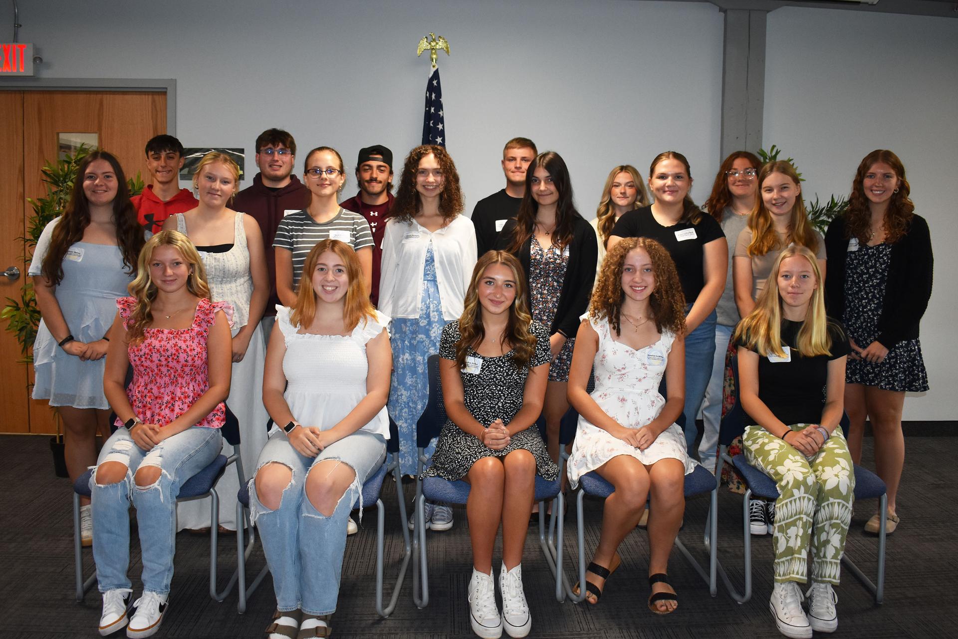 Students and science teacher with space seed capsule and certificate