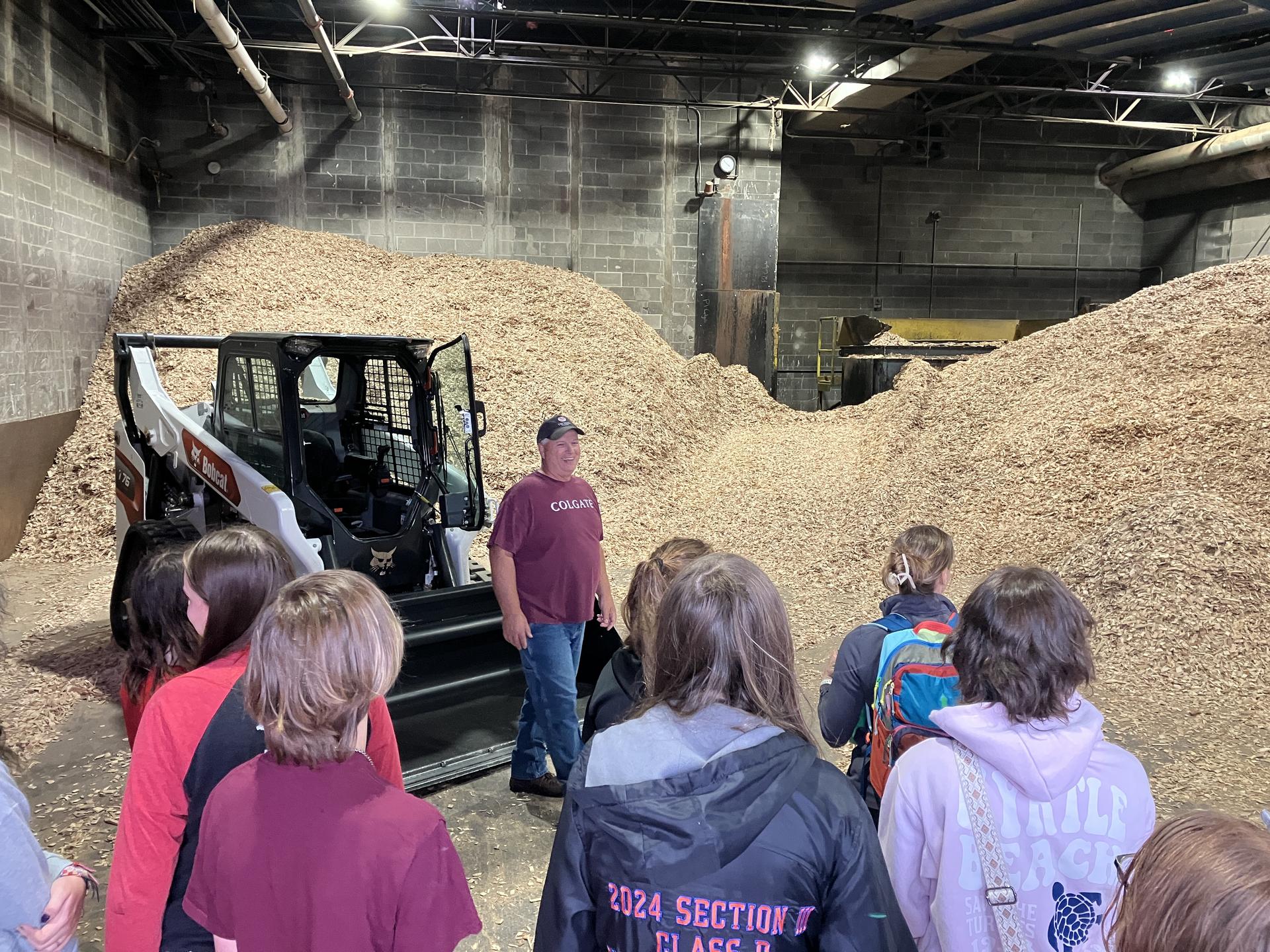 Students and science teacher with space seed capsule and certificate