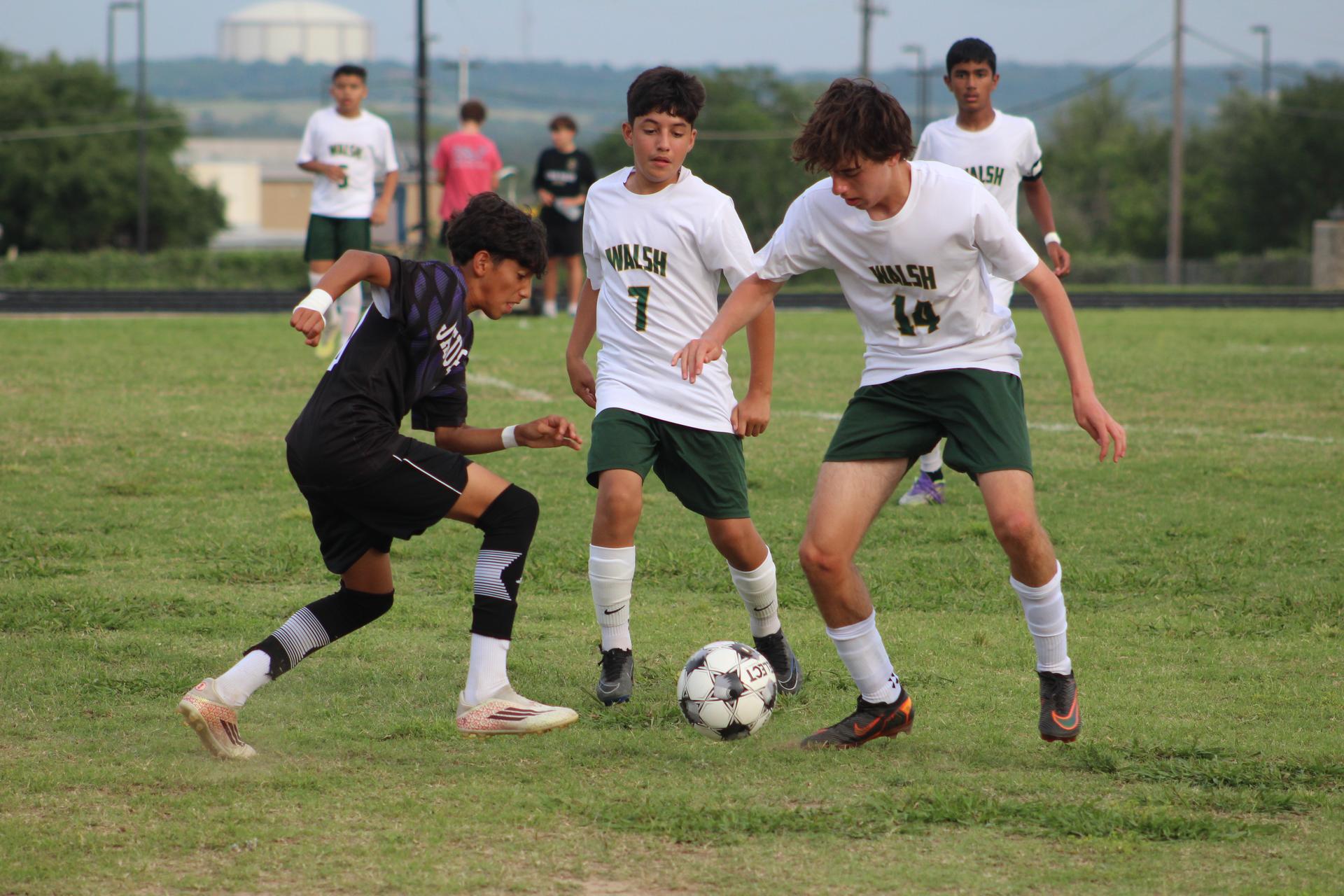 An action-packed shot from a middle school boys' soccer match between the Cedar Valley Jaguars and the Walsh Wildcats.
