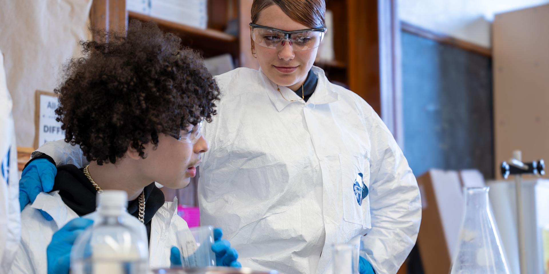 two students work work together during a science experiment