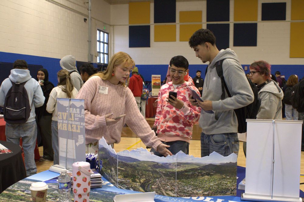 NEC students visit a table at a college fair