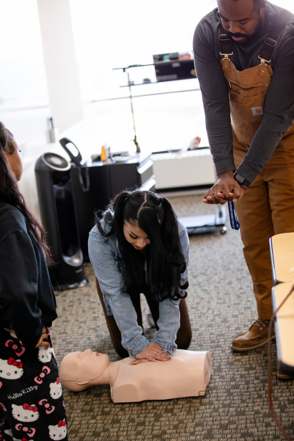 Student practicing CPR on a dummy