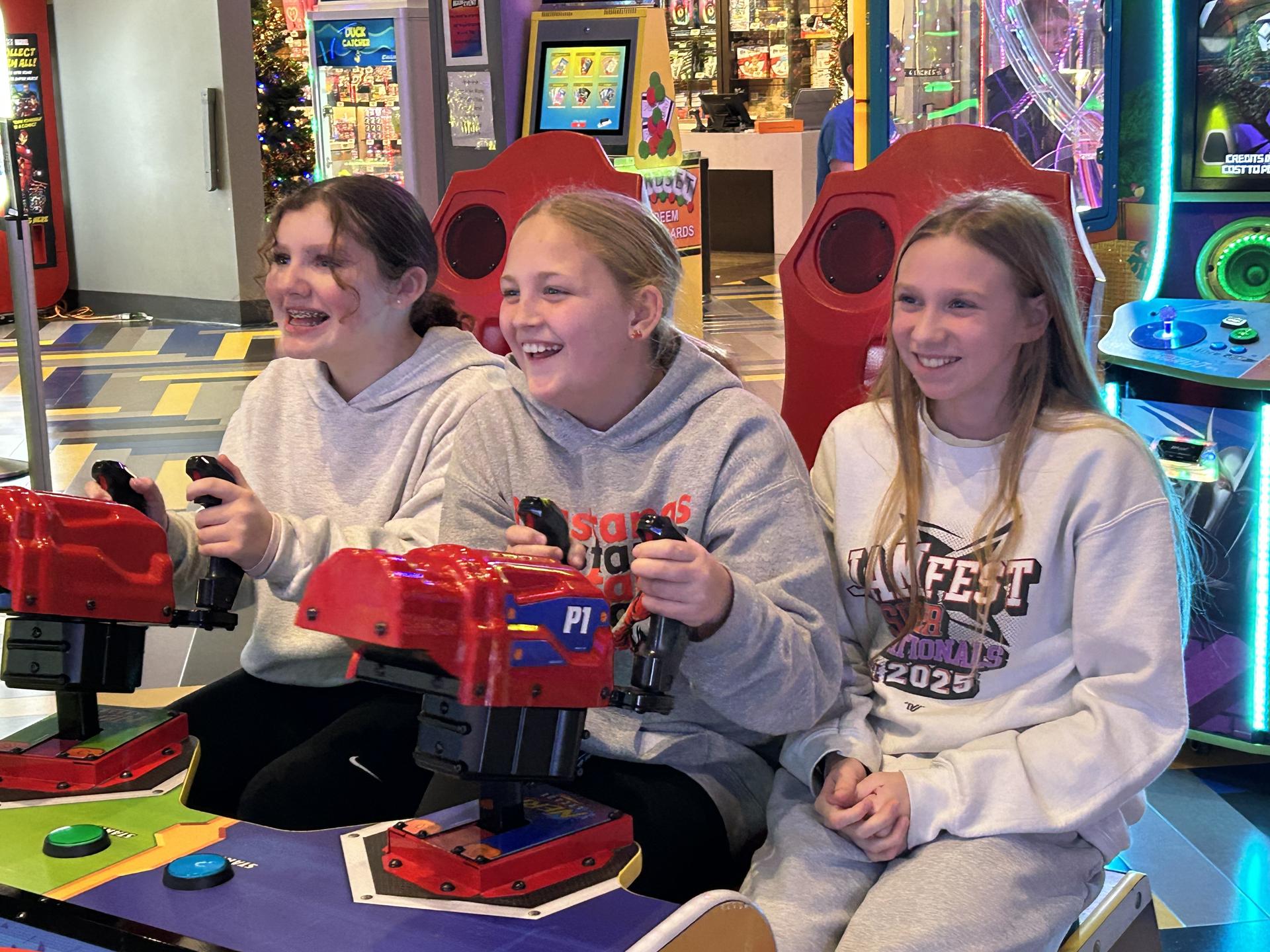 Students playing an arcade game