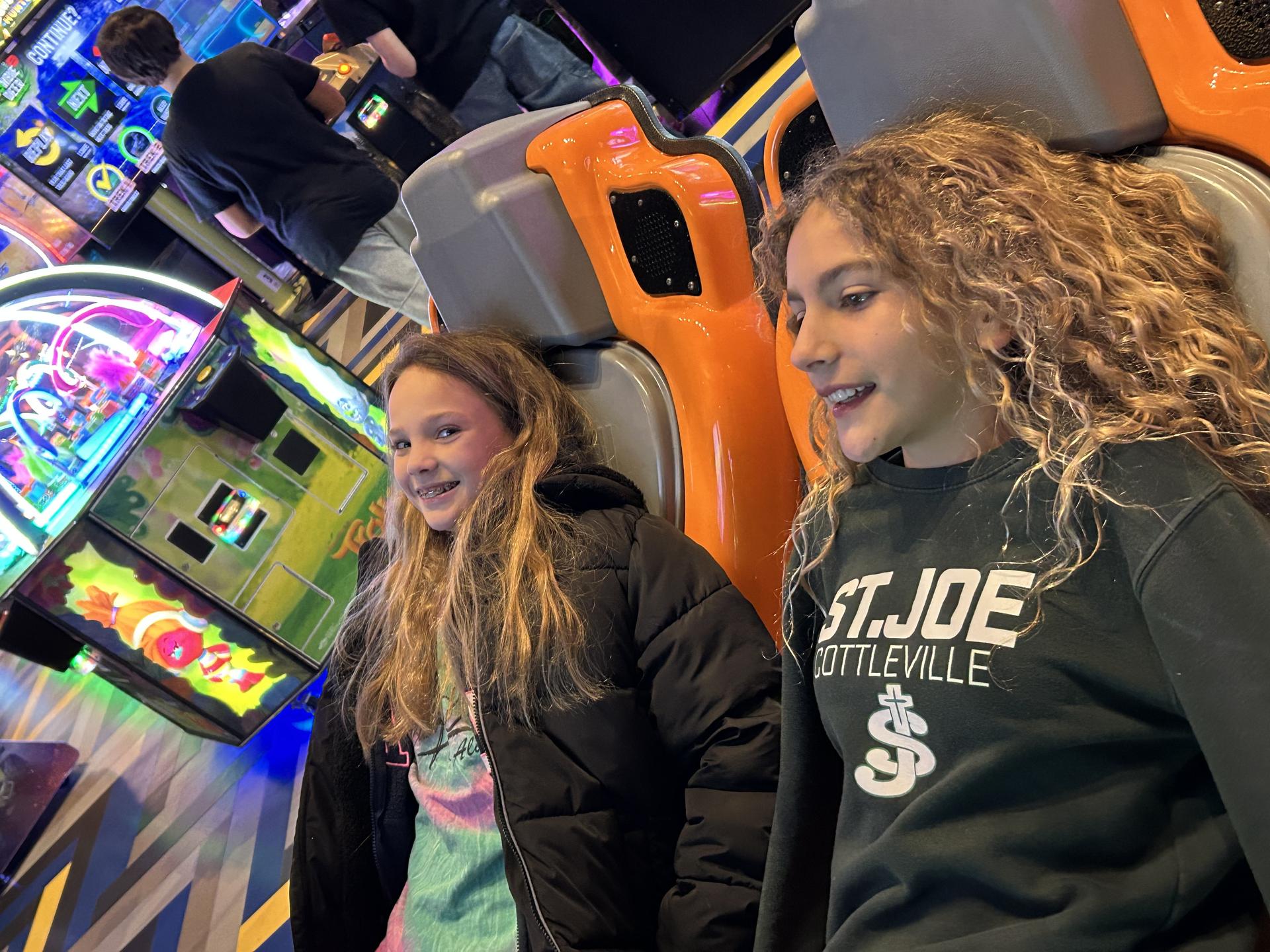 Students playing an arcade game