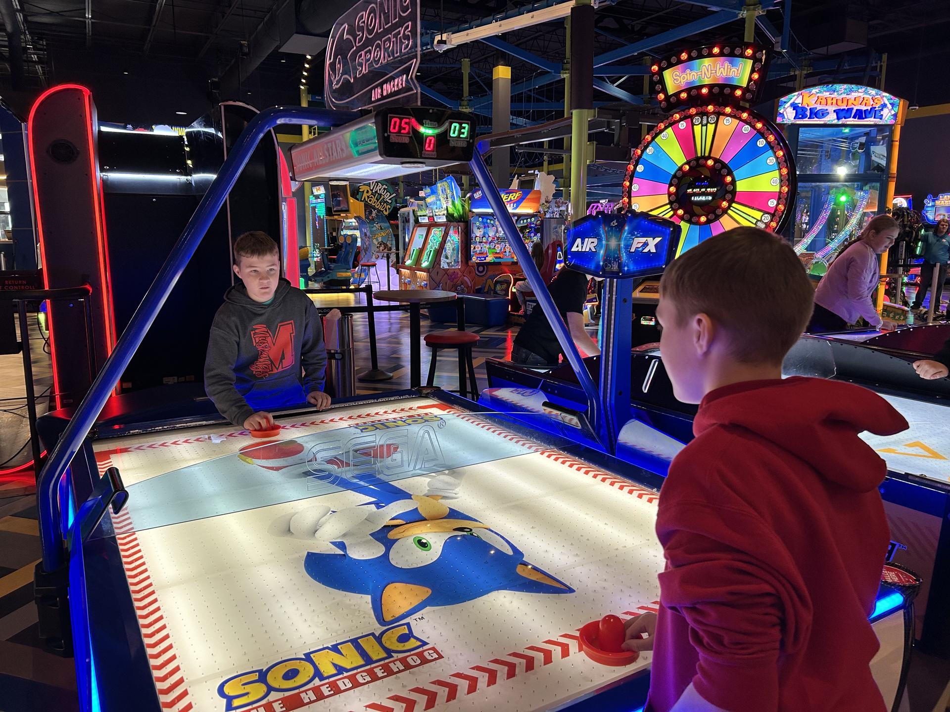Students playing an arcade game