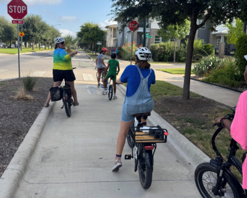 PHOTO OF STUDENTS RIDING THEIR BIKES
