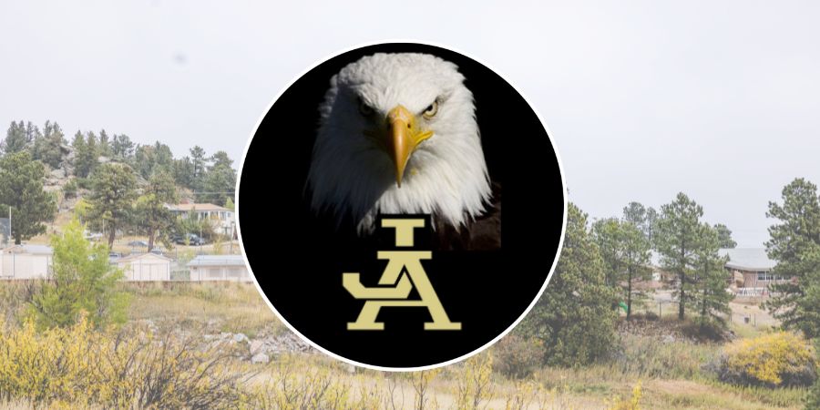 Picture of JA Eagle mascot, with school in background.