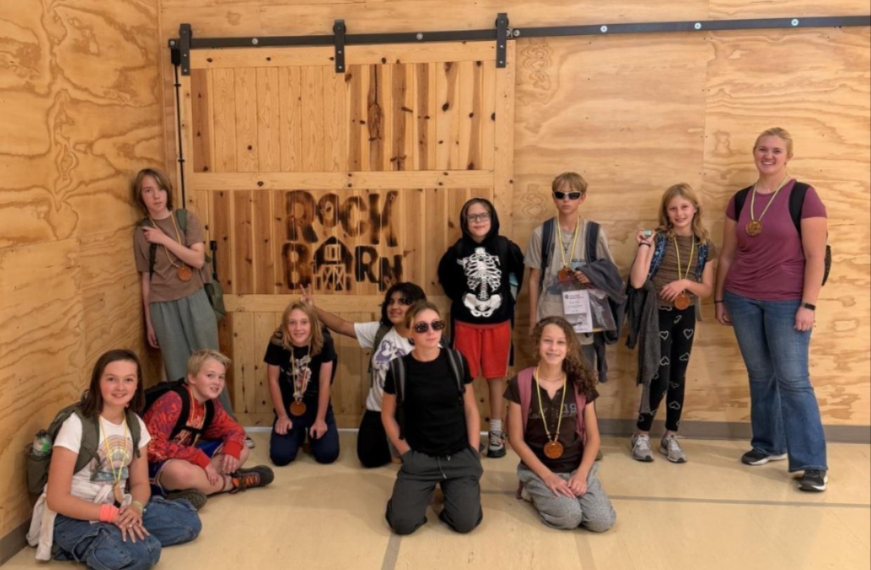 Image of students showing off their robotics project.