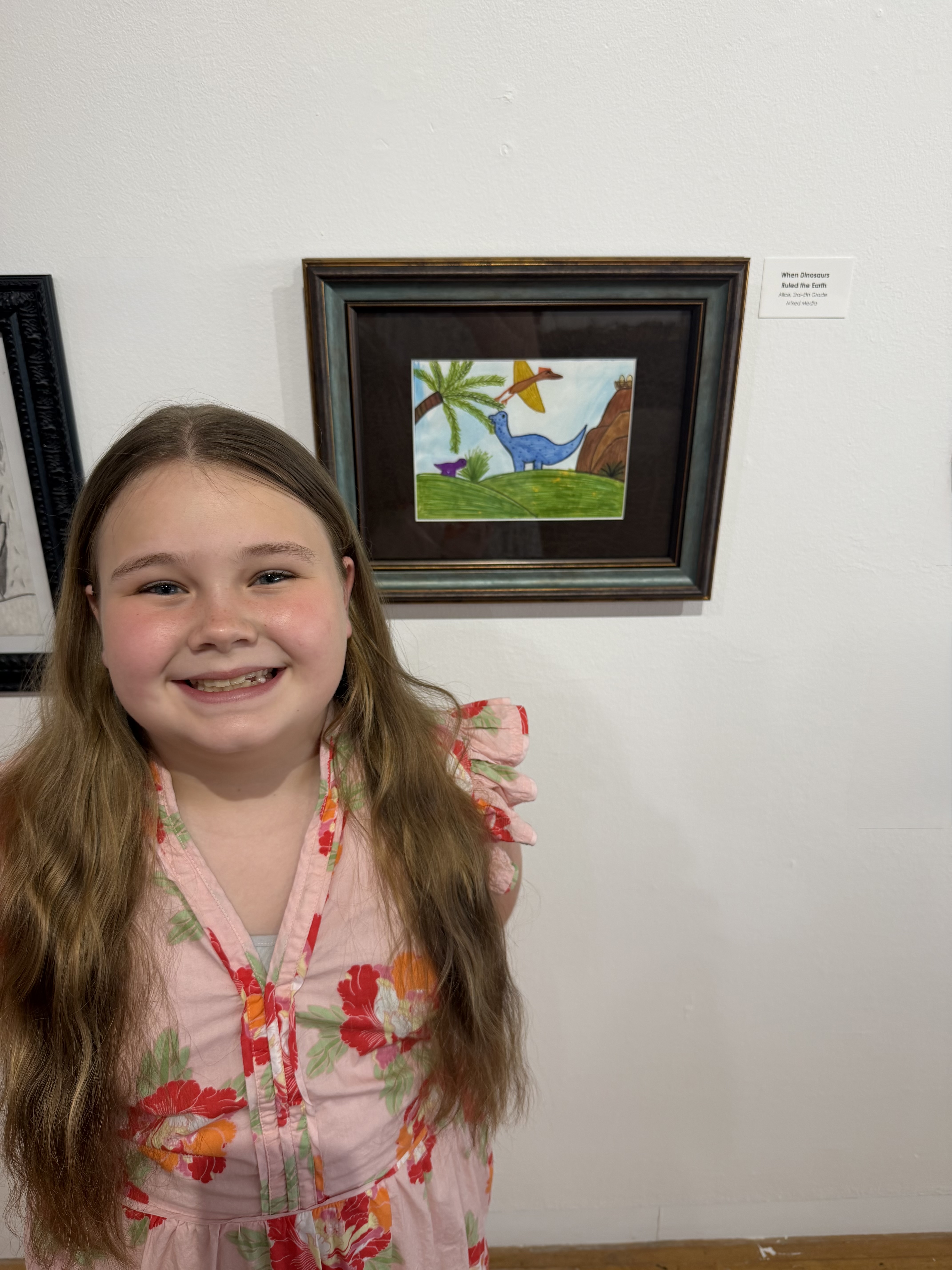 student posing with art 
