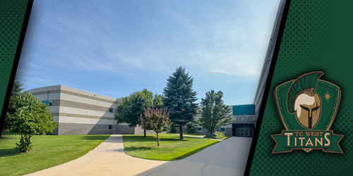 A wide-angle outdoor view of the Traverse City West Senior High school building on a clear, sunny day. The modern, tan and grey multi-story building is surrounded by a lush green lawn with several trees, including a large evergreen. A concrete walkway leads toward the main entrance. The image is framed by a dark green border on the right featuring the 
