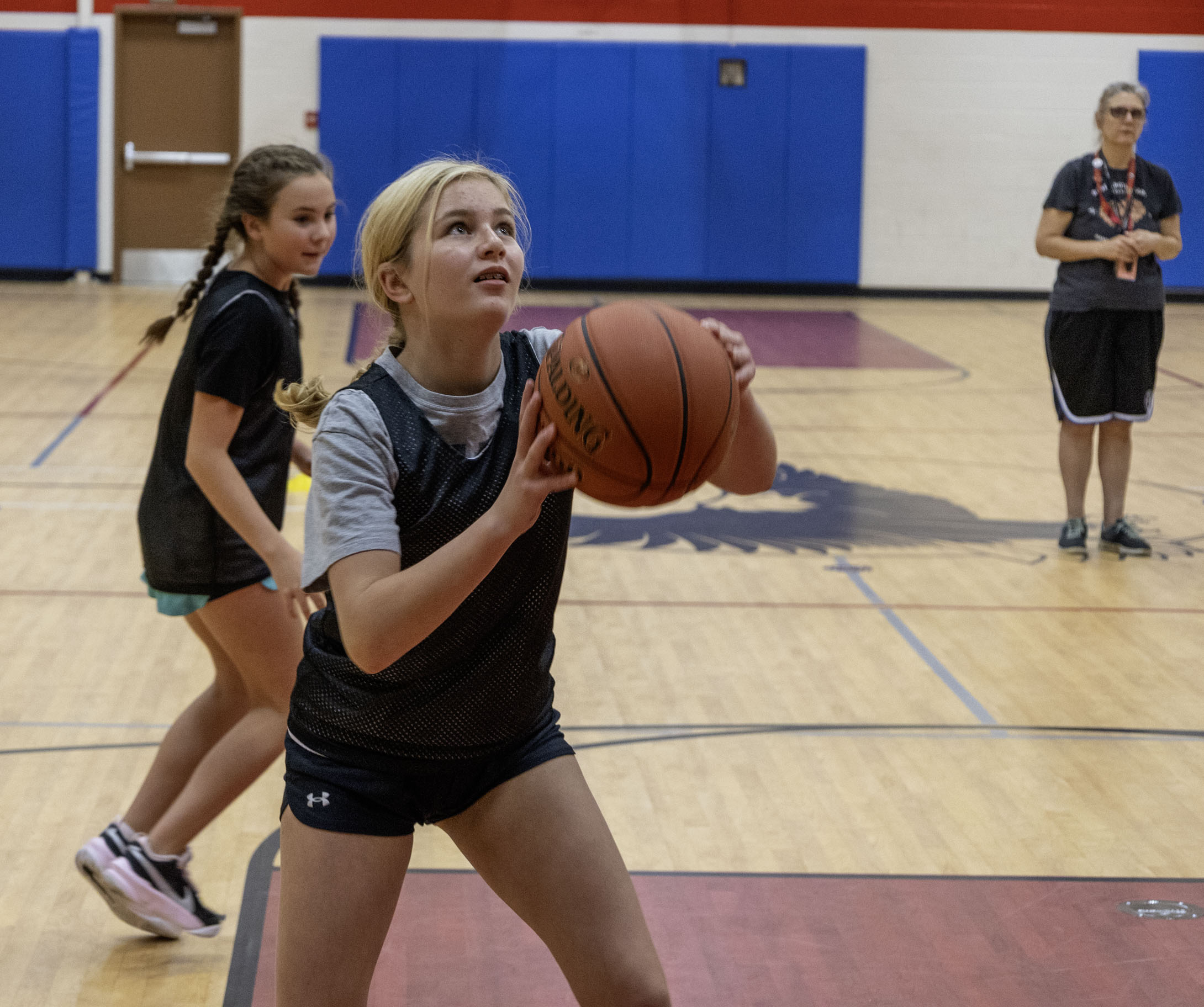 A middle schooler shooting a basketball